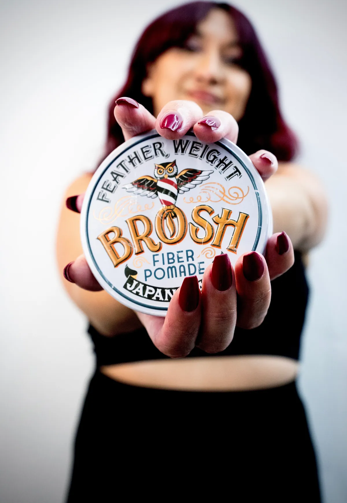 Ryah holding a jar of fiber pomade